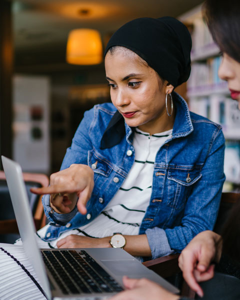 2 women looking at laptop