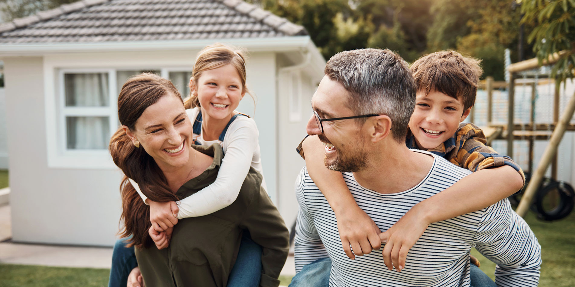 happy family of four playing outside