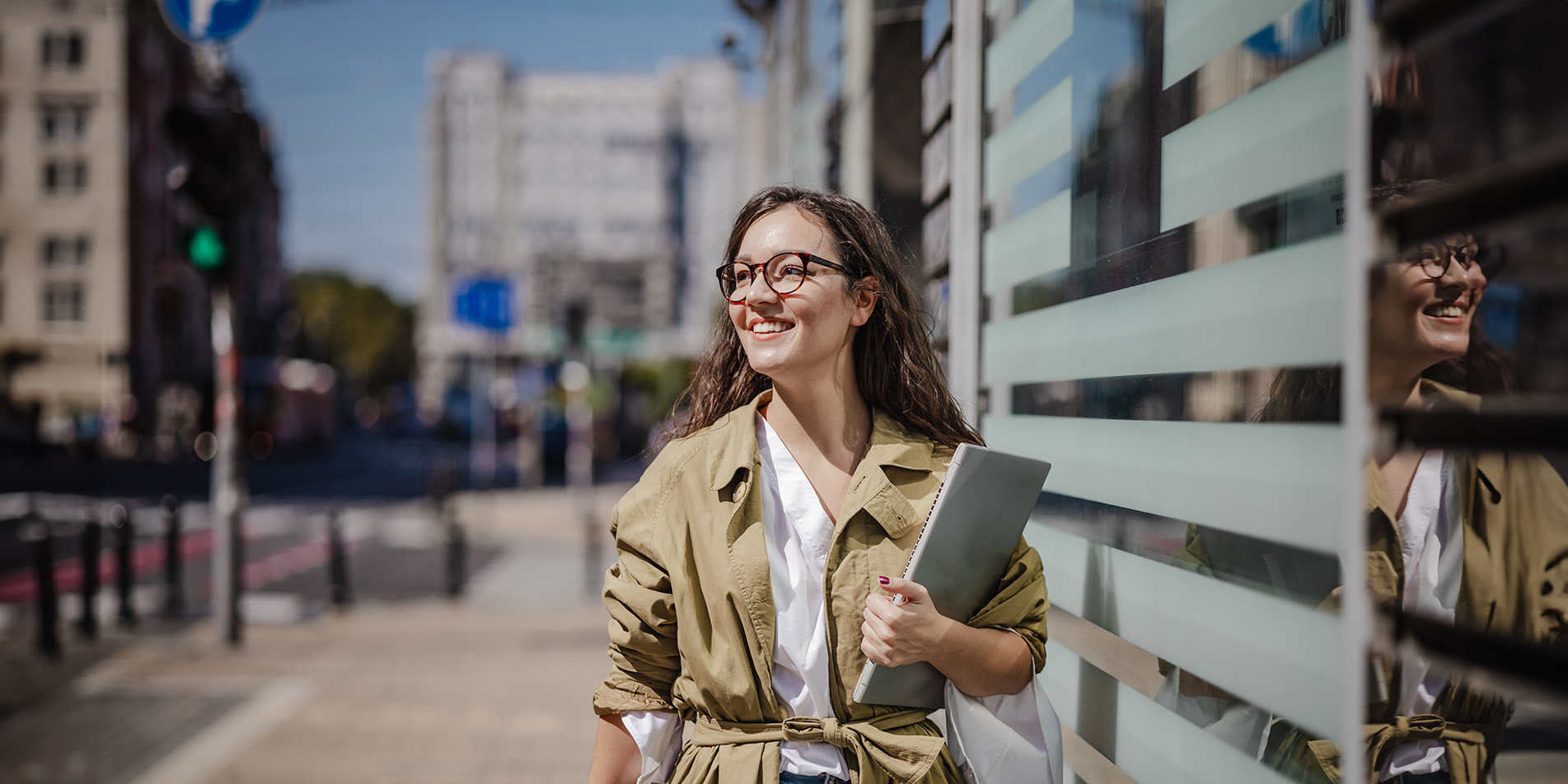 lady-on-street-with-notebook-in-hand-smiling