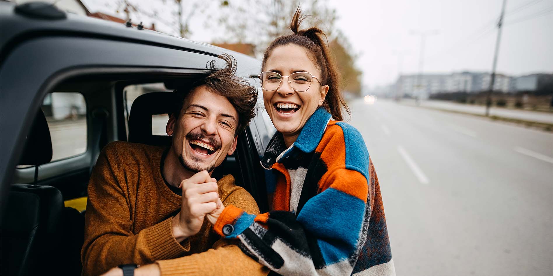 man-woman-next-to-a-car-iStock-1354238054